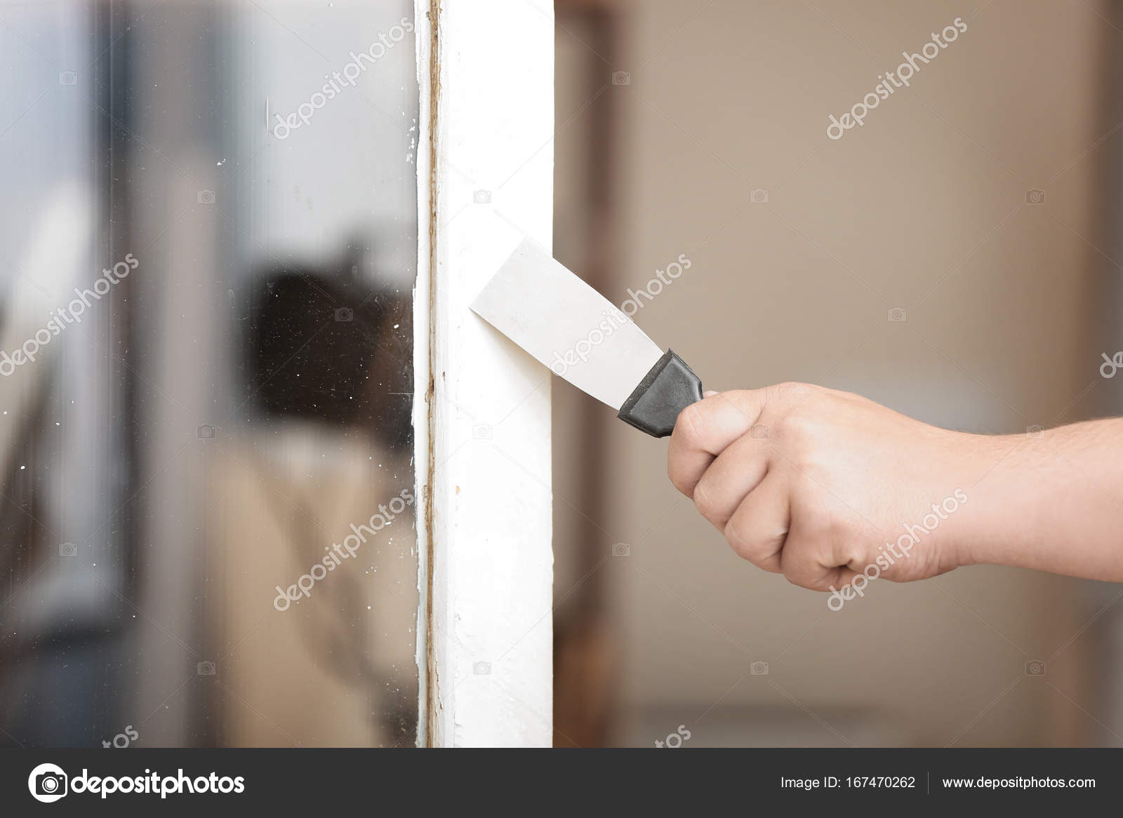 Worker Removing Paint From Old Window Frame Stock Photo