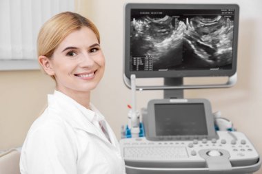 Female ultrasonographer in modern clinic clipart