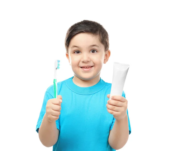 Cute boy with toothbrush and paste on white background. Teeth cleaning concept — Stock Photo, Image