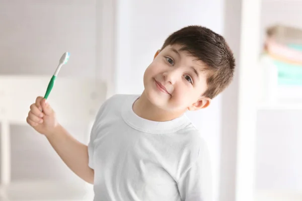 Menino bonito com escova de dentes em casa. Dentes de limpeza conceito — Fotografia de Stock