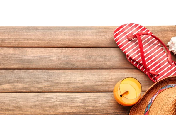 Glass of orange juice and flip-flops — Stock Photo, Image