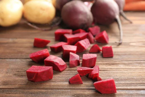 Chopped beet on wooden table — Stock Photo, Image