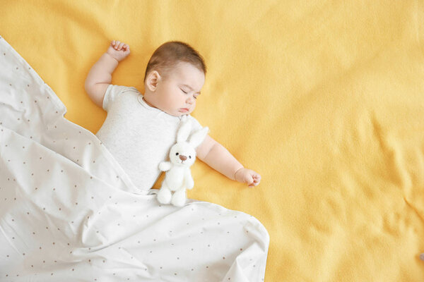 Cute little baby sleeping on bed