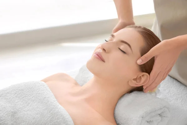Young woman enjoying of facial massage in spa salon — Stock Photo, Image
