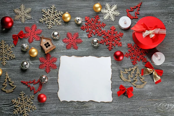 Foglio di carta bianca e decorazioni natalizie su tavolo di legno — Foto Stock