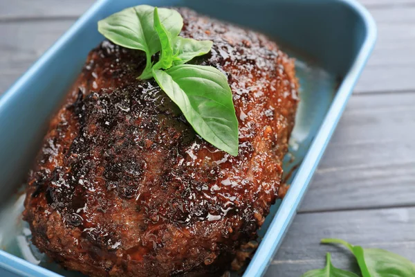 Baking dish with tasty turkey meatloaf on wooden table, closeup — Stock Photo, Image