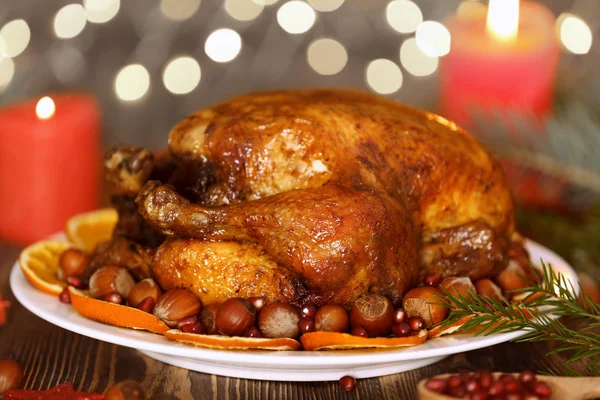 Composition with whole roasted turkey and hazelnuts against defocused lights — Stock Photo, Image