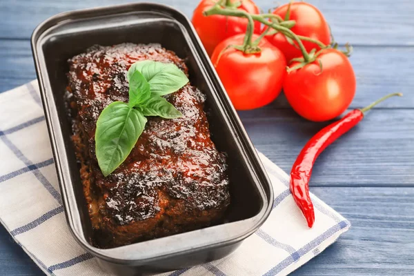 Baking dish with tasty turkey meatloaf on wooden table — Stock Photo, Image