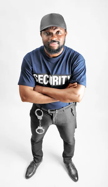 Male security guard on light background — Stock Photo, Image