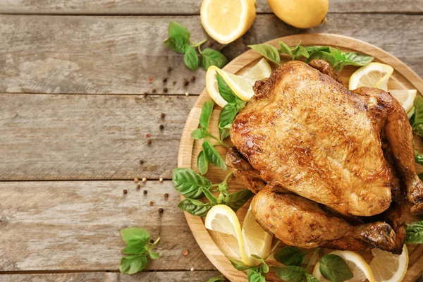 Tasty whole roasted turkey with lemon and basil on wooden board — Stock Photo, Image
