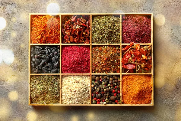 Different spices in wooden crate on table