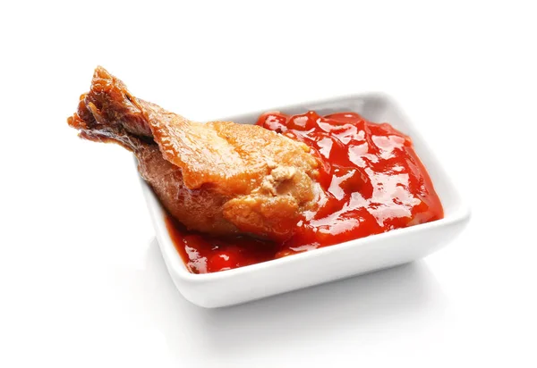 Roasted chicken leg in little bowl with tomato sauce on white background — Stock Photo, Image