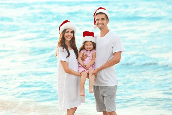 Pareja joven con linda chica en la playa. Concepto de Navidad —  Fotos de Stock