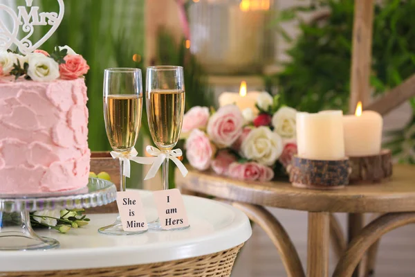 İki şampanya bardağı kek odasında masada ile. Kavram lezbiyen düğün — Stok fotoğraf