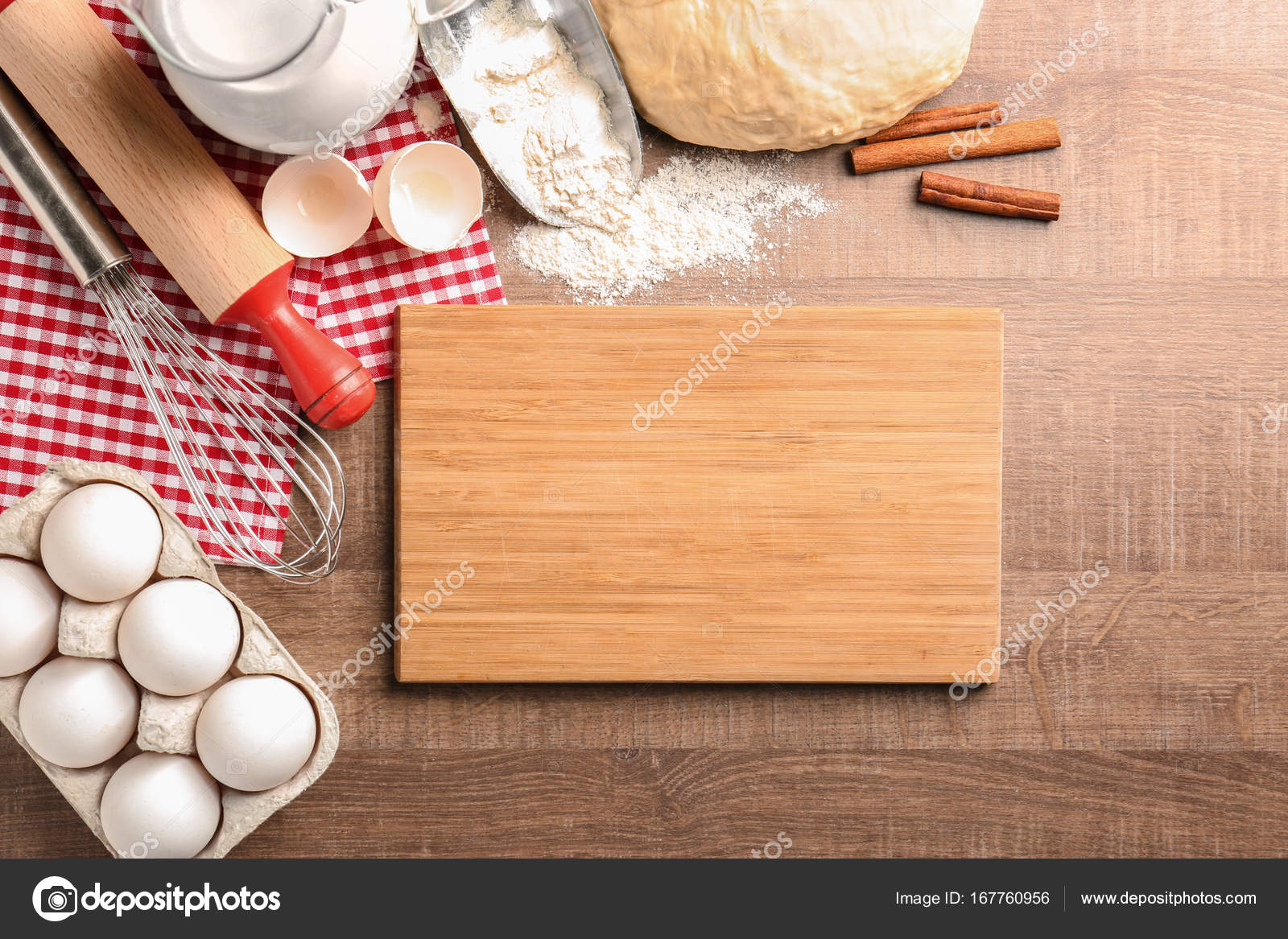 Wooden Board And Raw Dough With Ingredients On Kitchen Table