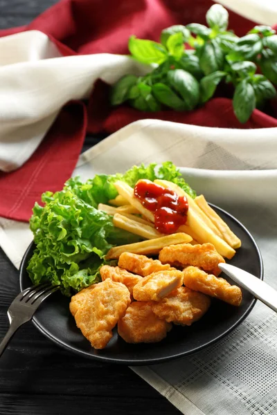 Tasty nuggets and french fries with sauce for chicken on plate — Stock Photo, Image