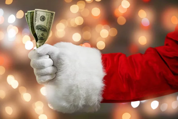 Santa Claus sosteniendo dinero — Foto de Stock