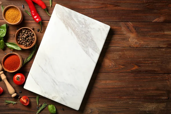 Composition with marble board and ingredients for cooking on wooden background — Stock Photo, Image