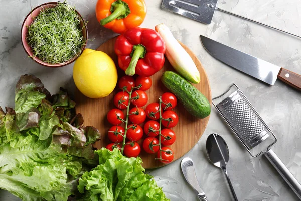 Tabla de madera con verduras y utensilios en la mesa de la cocina. Concepto de clases de cocina — Foto de Stock