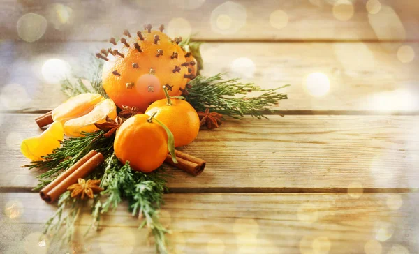 Composition of fruits, spices and coniferous branches on wooden background — Stock Photo, Image