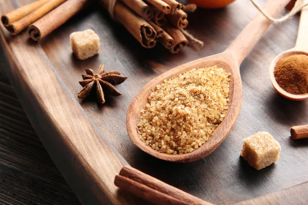 Cinnamon sugar in wooden spoon on serving board — Stock Photo, Image