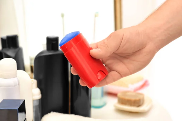 Hand of man with deodorant in bathroom — Stock Photo, Image