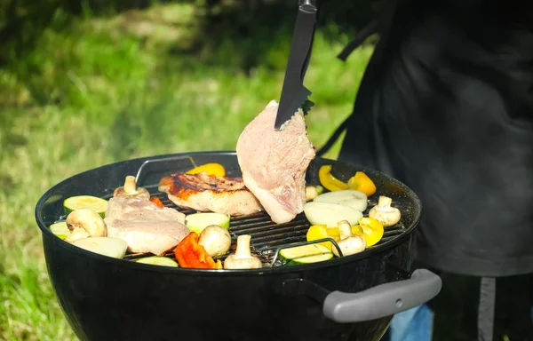 Preparing barbecue steaks on grill — Stock Photo, Image