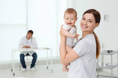 Genç anne ve bebek kız doktor ofisinde