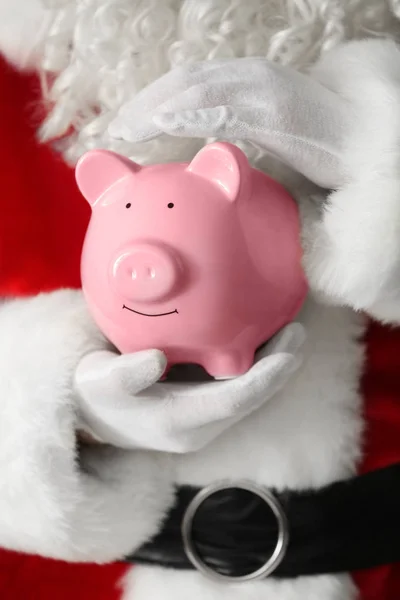 Santa Claus holding piggy bank, closeup — Stock Photo, Image