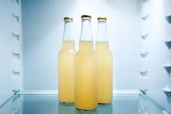 Bottles of fresh lemonade in fridge — Stock Photo, Image