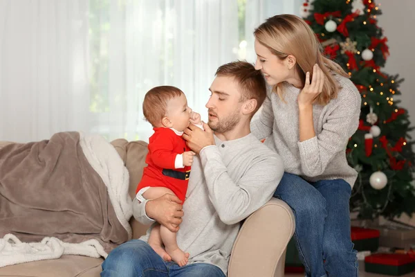 Happy parents with baby in decorated room for Christmas — Stock Photo, Image