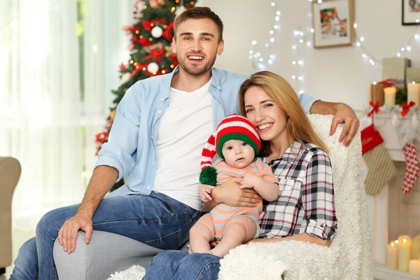 Lyckliga föräldrar med barn i inredda rum till jul — Stockfoto