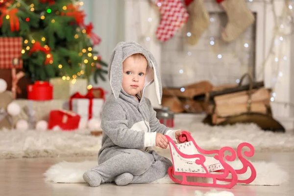 Sevimli küçük bebek giyen tavşan kostümünü odada Noel için dekore edilmiştir. — Stok fotoğraf