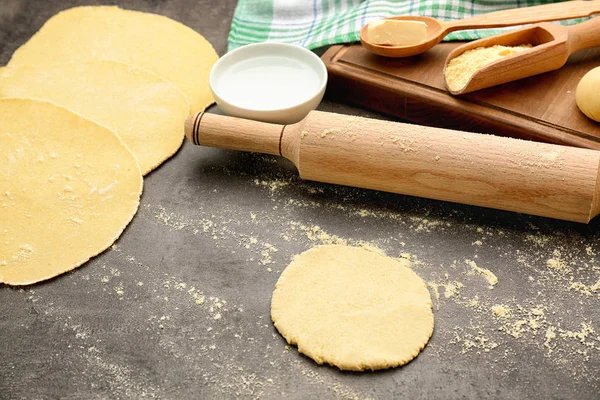 Dough for tortillas and rolling pin on kitchen table — Stock Photo, Image