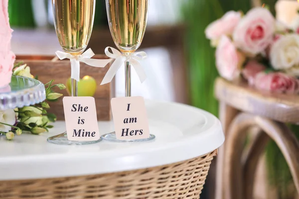 Copos de champanhe na mesa dentro de casa. Conceito de casamento lésbico — Fotografia de Stock