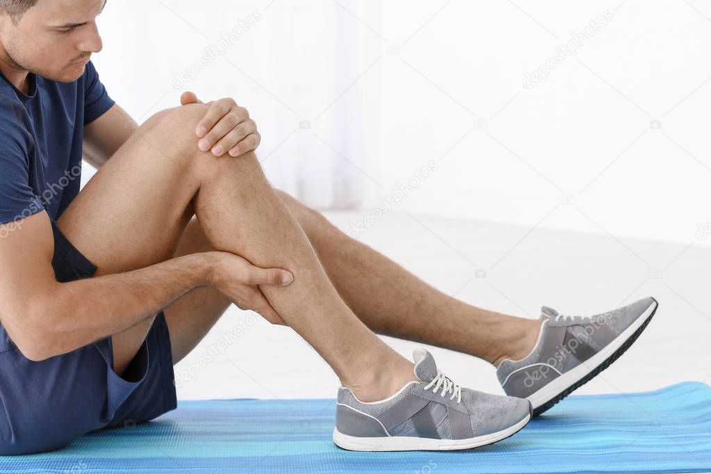man suffering from pain in leg