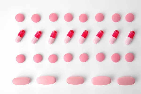 Pink pills on white background — Stock Photo, Image