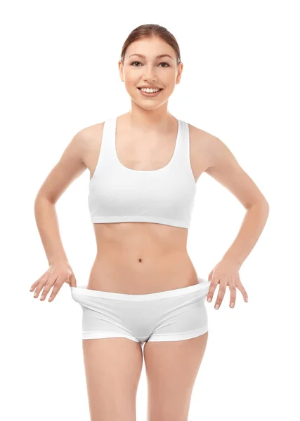 Schöne junge Frau in Unterwäsche auf weißem Hintergrund. Ernährungskonzept — Stockfoto