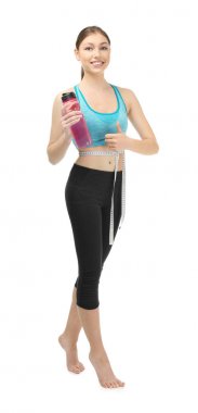 Beyaz arka planda mezurası ve bir şişe suyu olan güzel bir genç kadın. Diyet kavramı