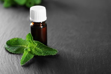 Esans ve masada nane yaprakları ile şişe