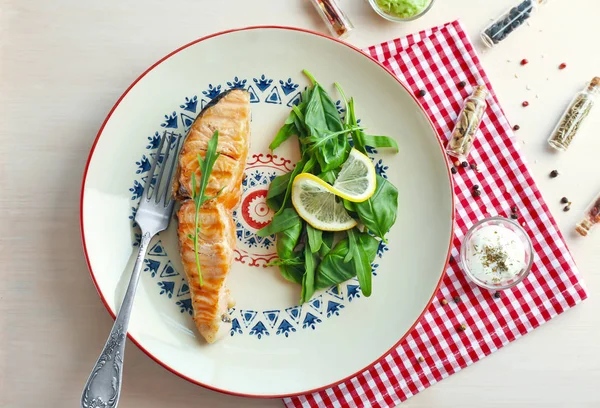 Lezzetli somon dilim, otlar ve sos masada küçük kase ile plaka