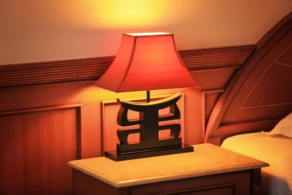 Lamp on night stand in modern hotel room