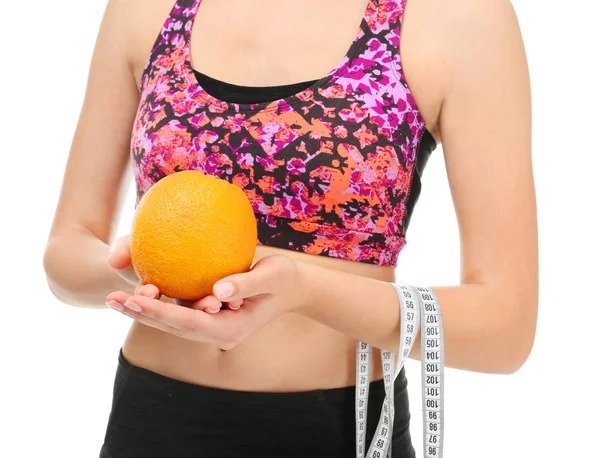 Young woman with measuring tape and orange on white background. Diet concept — Stock Photo, Image