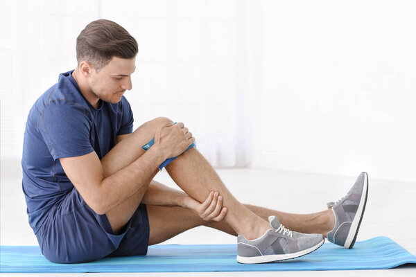 man suffering from pain in leg