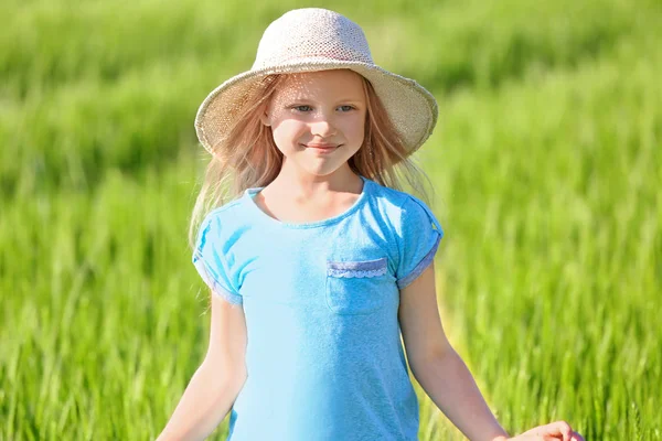 Happy little girl in green field — Stock Photo, Image