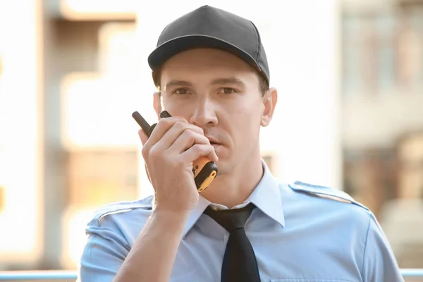 Male security guard with portable radio, outdoors — Stock Photo, Image