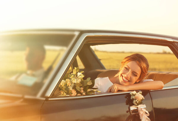 bride in decorated car