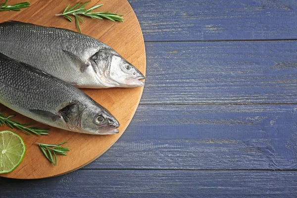 Fresh fish on wooden board — Stock Photo, Image