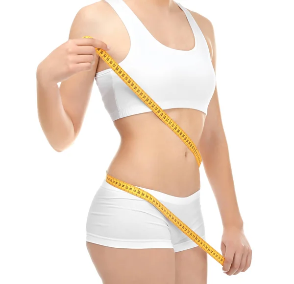 Mujer joven en ropa interior con cinta métrica sobre fondo blanco. Concepto de dieta — Foto de Stock