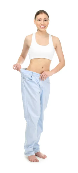 Красива молода жінка в джинсах на білому тлі. Концепція дієти — стокове фото